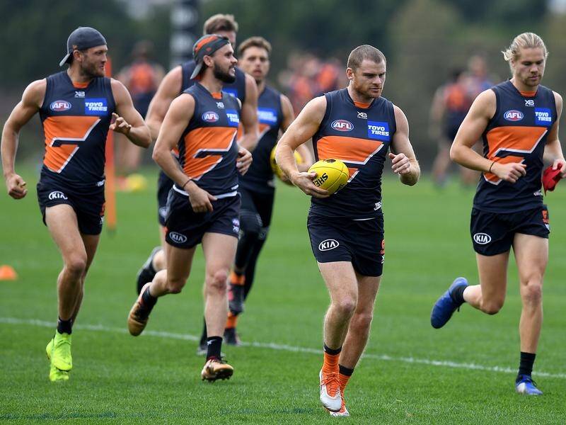 GWS's Heath Shaw (centre) comes up against brother and Kangaroos interim coach Rhys Shaw on Sunday.