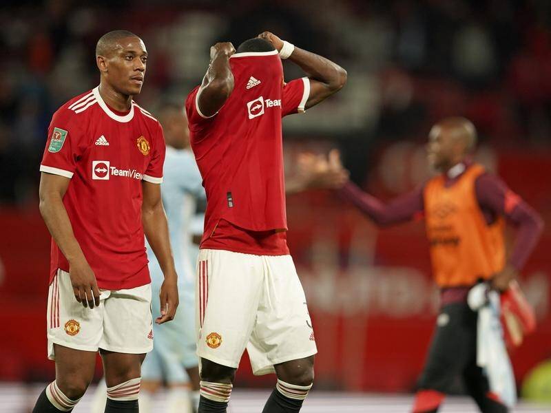 Anthony Martial (l) and Eric Bailly trudge off Old Trafford after Man United's Cup loss to West Ham.