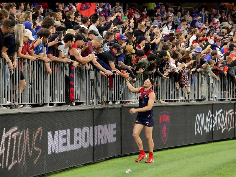 Steven May, who tore his hamstring again in the grand final, soaks up the fans' plaudits.