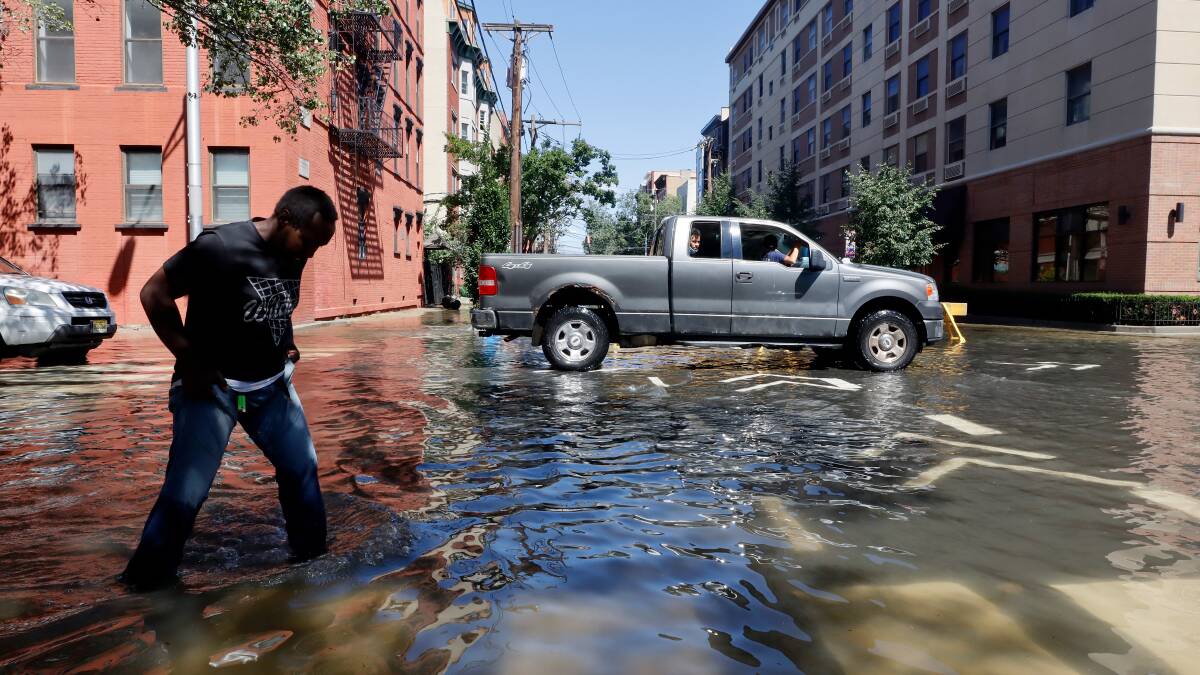 A man walks through a flooded street in Hoboken after remnants of Hurricane Ida drenched the New York City and New Jersey area last week. Picture: Getty Images