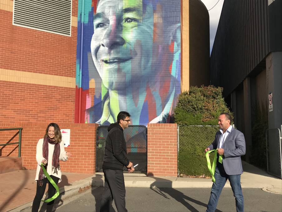 Recognised: Ricky Stuart (right) had his mural painted by artist Clare Foxton (left) in Bicentennial Hall. Ricky was nominated by Dimitri Hantas (middle). Photo: supplied. 
