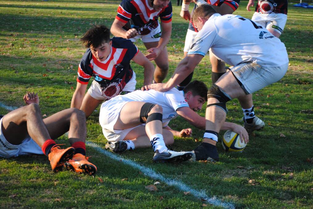 Try time: The Queanbeyan Whites won their third game of the season after a late try and penalty sealed a tight and nail-biting contest. Photo: Burney Wong. 