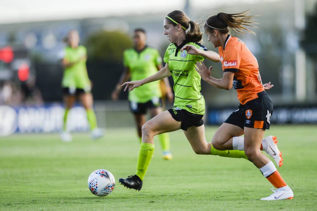 Dribble: Karly Roestbakken of Canberra (left) and Indiah-Paige Riley of Brisbane (right) in a match between Canberra United and Brisbane Roar. Photo: Rohan Thomson.