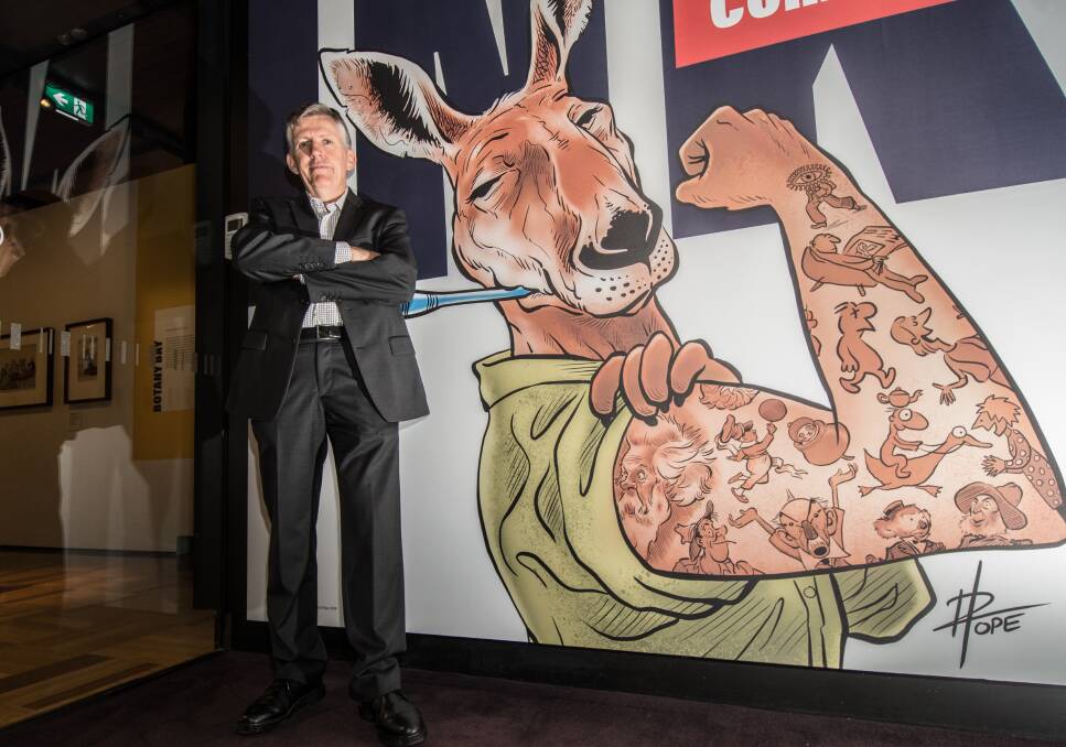 EYE TOONS: Guy Hansen, curator of the Inked: Australian Cartoons exhibition at the National Library of Australia in Canberra, with the exhibition's highly decorated kangaroo mascot by cartoonist David Pope. Photo: Karleen Minney
