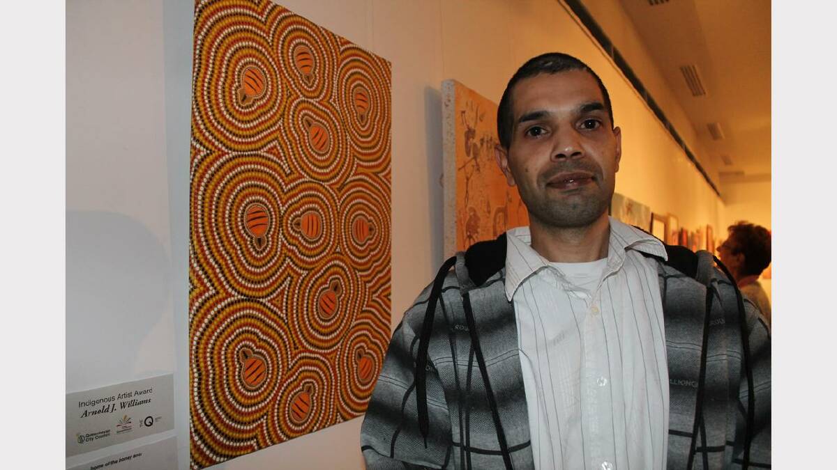 Indigenous Artist Award winner Arnold J Williams and his piece titled 'Papunya, Home of the Honey Bees'.
