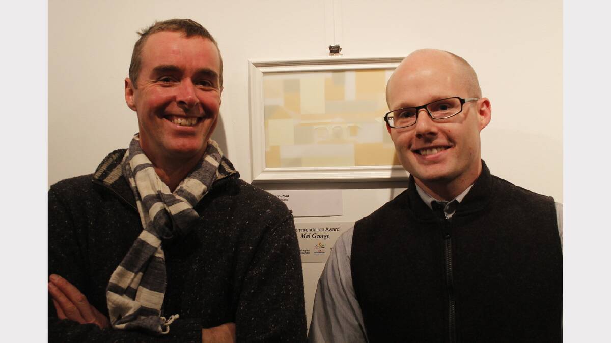 Matt Curtis and Jeremy Lepisto pose in front of Mel George's glass artwork 'Henderson Road'.